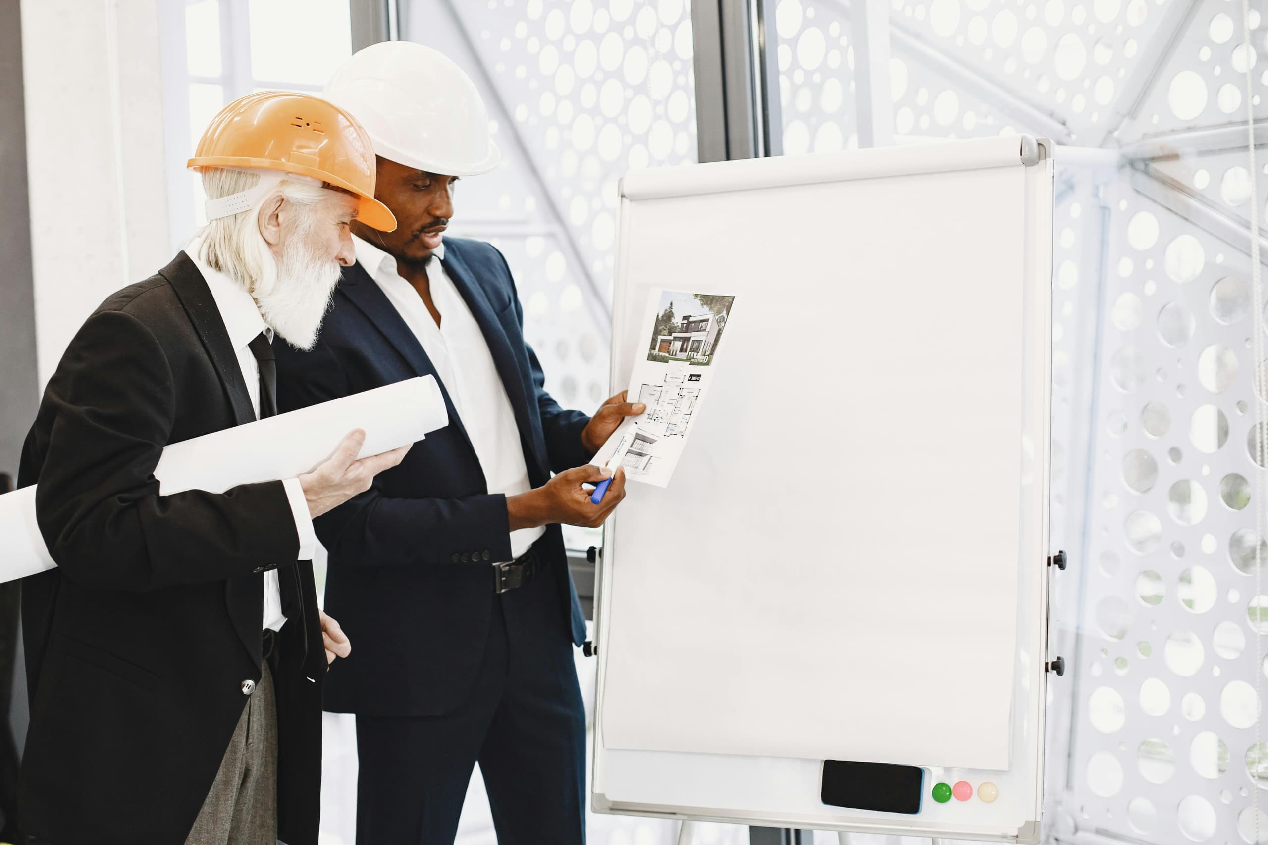 Advisors reviewing construction plans and documents at a conference table